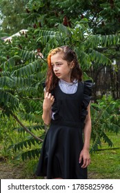 Wet Schoolgirl Standing In The Rain. Girl Wet. Teenager In School Uniform In Spring Or Warm Autumn. Girl 5th Grade. Hair Coloring. Portrait Of A Schoolgirl With Splashes Of Water. Back To School