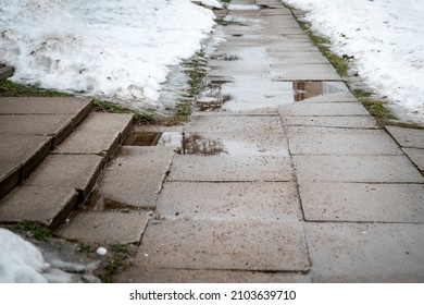 Wet And Slippery Sidewalk. Spring, Thaw And Change Of Weather.