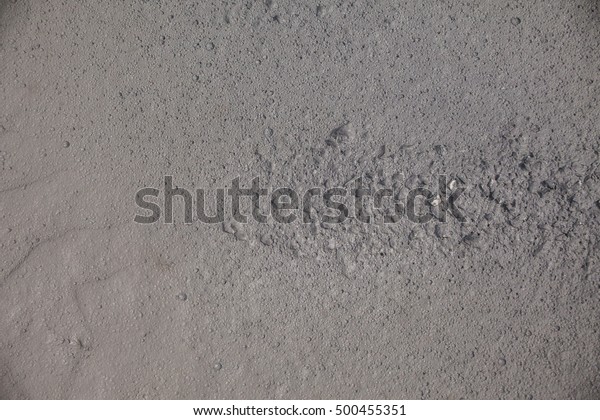 Wet soil textured surface background under\
bright sunlight and looklike moon\
surface