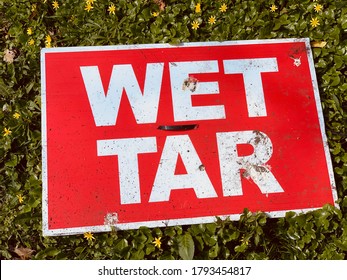 Wet Tar Sign On Ground, Red And Green