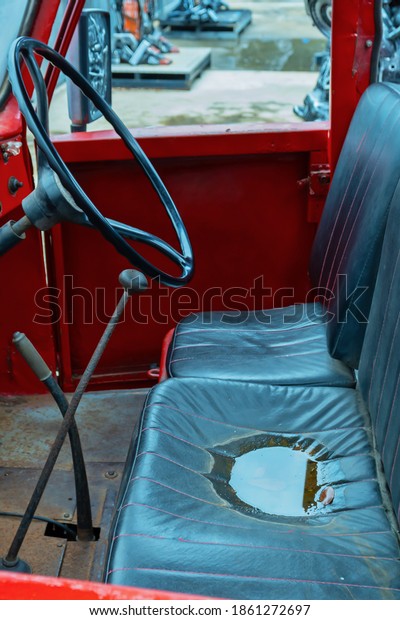 Wet truck seat\
after rain. Blurred\
background.