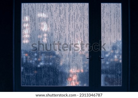 Wet window after autumn or winter rain. autumn depression, mental health concept. Window in dark room, outside window is rain and gray dull city