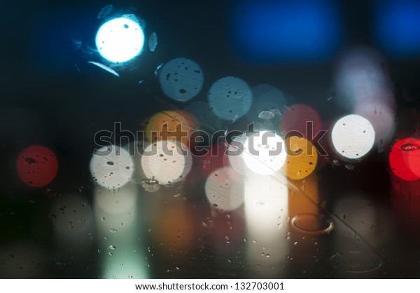 Wet the\
window with the background of the night\
city