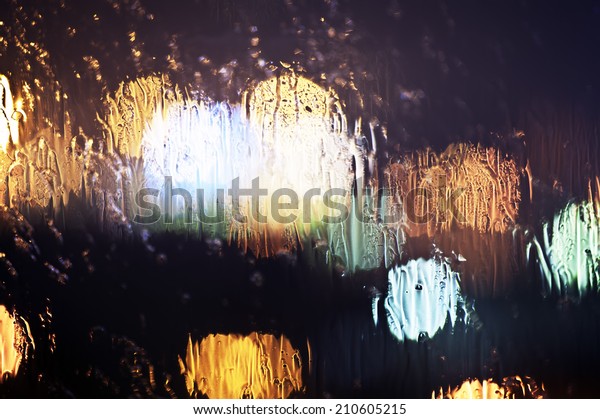 Wet the\
window with the background of the night city\
