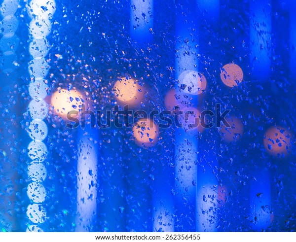 Wet the\
window with the background of the night city\
