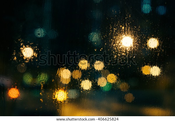 Wet the\
window with the background of the night\
city
