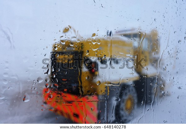Wet window and a big truck\
in snow