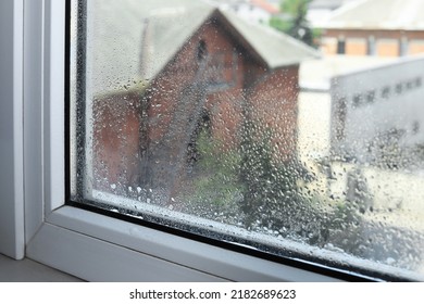 Wet Window On Rainy Day, Closeup. View From Inside