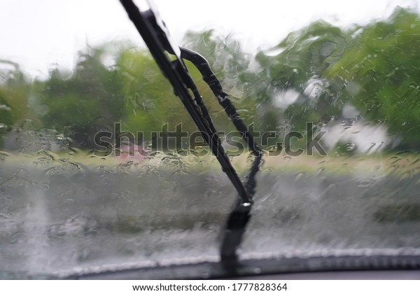 Wet\
windows from rain dropping onto the windshield. \
