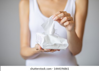 Wet wipes are universal an practical: woman take one wipe from big package for cleaning