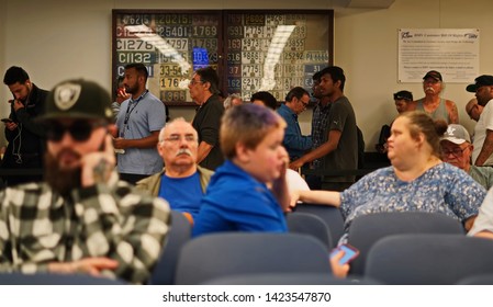 Wethersfield, CT / USA - June 11, 2019: Snapshot Of A Bored Crowd Of People In The Waiting Area (focus On Those Standing In Line)