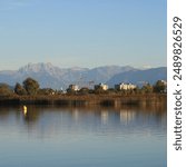 Wetzikon, shore of Lake Pfaeffikersee and mountain ranges.