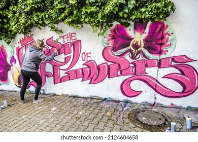 WETZLAR, GERMANY - 23.05.2021: Young female Artist doing artificial typography colorful graffiti senic on house facade in WETZLAR; GERMANY - Shutterstock ID 2124604658