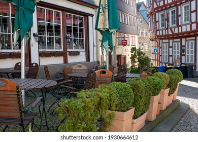 Wetzlar, Hessen, Germany - 06.03.2021: Empty Restaurant Outdoors Chairs Stacked Up During Corona Pandemic Covid-19 Businesses Empty Streets No Business Crisis, Lockdown New Normal Economy