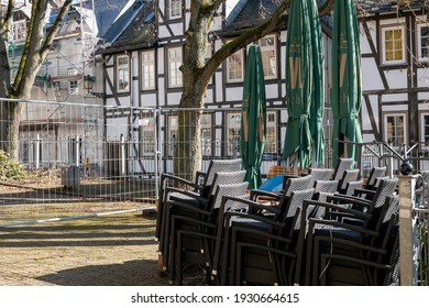 Wetzlar, Hessen, Germany - 06.03.2021: Empty Restaurant Outdoors Chairs Stacked Up During Corona Pandemic Covid-19 Businesses Empty Streets No Business Crisis, Lockdown New Normal Economy