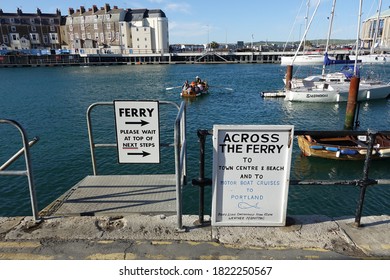 Weymouth Dorset England. September 2020. A Rowing Boats With Rower And Passengers. The Craft Is The Ferry Linking Either Side Of The Harbour.
Signage On Harbourside. Quayside Buildings 