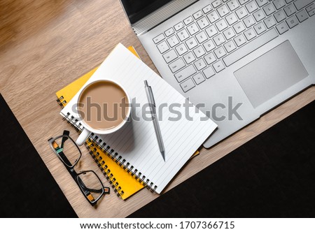 WFH - Work from Home Flatlay Photo of Desk with Laptop, Notepad, Glasses and Cup of Tea