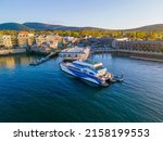 Whale watch ship aerial view docked at pier at sunset in historic town center of Bar Harbor on Mt Desert Island, Maine ME, USA. 