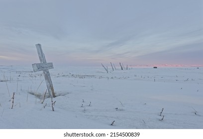 Whalers graveyard on Herschel Island, Beaufort Sea coast Yukon, Canada  Markers near Pauline Cove, Richardson Mountains in background in winter