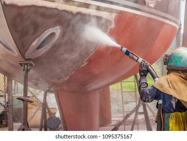 Whangarei,New Zeland/North Island,12-05-2017, man, sandblasting the corroded hull of a sailboat