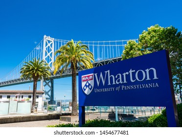 Wharton University Of Pennsylvania Sign Near School Campus With San Francisco–Oakland Bay Bridge In Background - San Francisco, California, USA - July 12, 2019