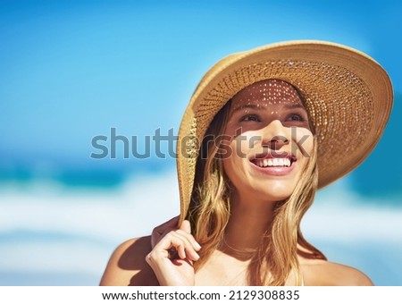 What an amazing summers day. Shot of a gorgeous young woman in a bikini at the beach.