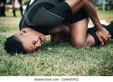 What a bad mishap. Cropped shot of a handsome young rugby player suffering with an injury on the field. - Powered by Shutterstock