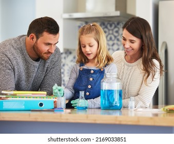 What Did Your Notes Say. Shot Of A Family Completing Science Experiments At Home.