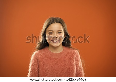 What is difference between phony and sincere smile. What science has to say about genuine and fake smiles. Child long hair happy smiling. Happy childhood concept. Girl cute child happy smiling face.