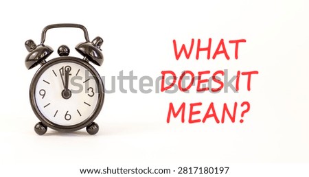 What does it mean symbol. Concept words What does it mean on beautiful white paper. Beautiful white background. Black alarm clock. Business What does it mean motivational support concept. Copy space.