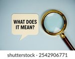 What does it mean? text on speech bubble with magnifying glass top view on blue background