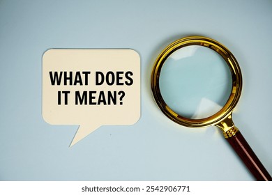 What does it mean? text on speech bubble with magnifying glass top view on blue background