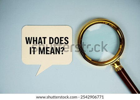 What does it mean? text on speech bubble with magnifying glass top view on blue background