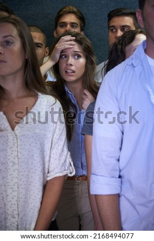 What am I going to do. Shot of a fearful young woman feeling trapped by the crowd.