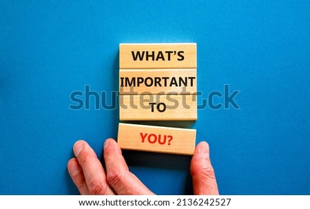 What is important to you symbol. Concept words What is important to you on blocks. Businessman hand. Beautiful blue table blue background. What is important to you business concept. Copy space.