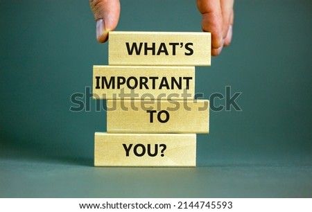What is important to you symbol. Concept words What is important to you on blocks. Businessman hand. Beautiful grey table grey background. What is important to you business concept. Copy space.