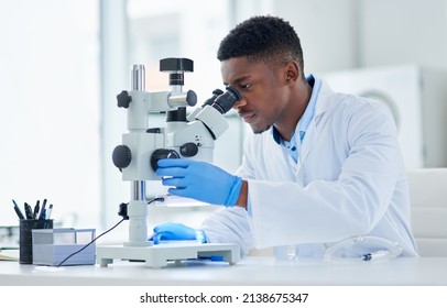 What an interesting find. Cropped shot of a focused young male scientist looking at test samples through a microscope inside of a laboratory during the day. - Powered by Shutterstock