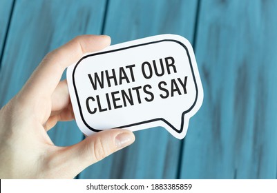 What Our Clients Say Text On Card In Hand.