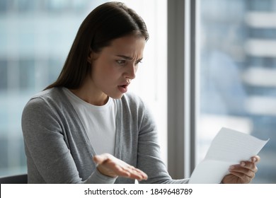 What is it? Shocked millennial businesswoman office worker receiving official refusal of visa or credit by mail, stressed young female learning bad news of debt bankruptcy of her business of a letter