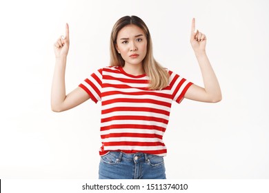 What That. Confused Bossy Young Unsure Intense Asian Blond Girlfriend Pointing Raised Index Fingers Up Showing Supicious Uncertain Product Look Camera Hesitant Perplexed Cannot Understand