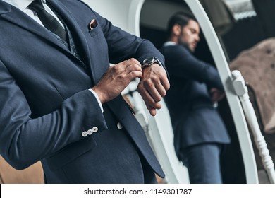 What Time Is It? Close Up Of Young Man In Full Suit Checking The Time While Standing In Front Of The Mirror Indoors