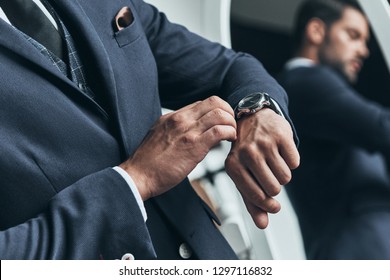 What Time Is It? Close Up Of Young Man In Full Suit Checking The Time While Standing In Front Of The Mirror Indoors