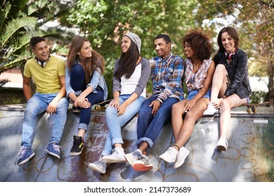 What Are We Gonna Do This Summer. Shot Of A Group Of Young Friends Hanging Out At A Skate Park.