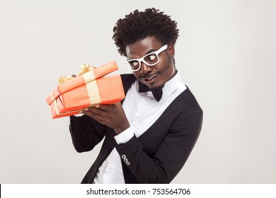 What is inside? Well dressed cunning man looking inside box. Indoor shot - Powered by Shutterstock