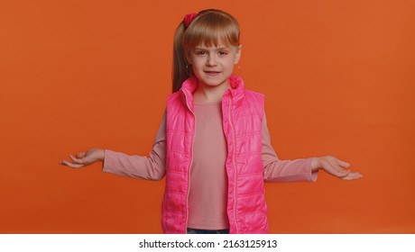 What Why. Sincere Irritated Little Girl Raising Hands In Indignant Expression Asking Reason Of Failure Demonstrating Disbelief Irritation By Troubles. Confused Child Isolated On Orange Wall Background