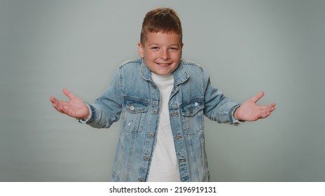 What Why. Sincere Irritated Toddler Boy Raising Hands In Indignant Expression Asking Reason Of Failure Demonstrating Disbelief Irritation By Troubles. Confused Teenager Child Kid On Gray Background