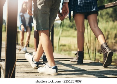 What will nature teach us today. Shot of a group of unrecognisable teenagers walking through nature together at summer camp. - Powered by Shutterstock