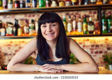 What Would You Like To Order. Cropped Shot Of A Waitress Standing Behind The Counter At A Bar.