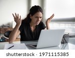 What is wrong. Anxious angry hispanic female splash hands unable to access database on laptop forgetting password having weak wifi signal. Mad shocked young woman worker losing job result on broken pc
