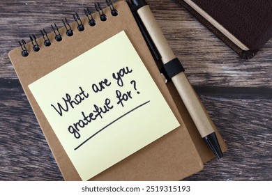 What are you grateful for, inspirational handwritten note with pen and holy bible book on wooden desk. Top view. Christian biblical concept of gratitude and thanksgiving to God Jesus Christ. - Powered by Shutterstock